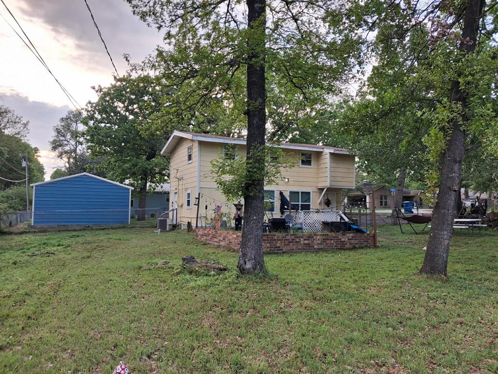 304 Ridgewood Drive Tool, TX 75143 - Photo 1 of 12 a front view of a house with garden and trees