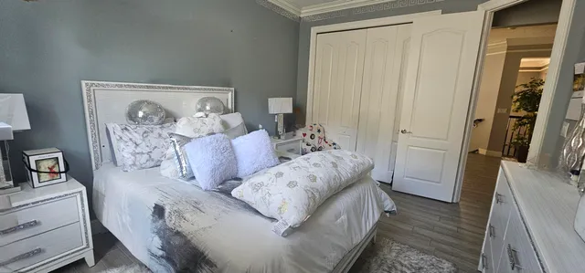 a bed room with a bed and a chair