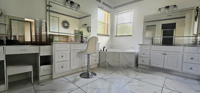 a kitchen with granite countertop a refrigerator and a sink