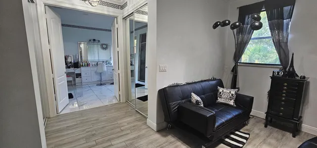 a view of a dining room with furniture and a window