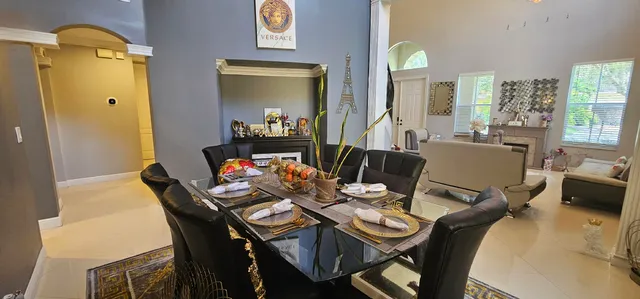 a kitchen with stainless steel appliances kitchen island granite countertop a refrigerator a stove and a sink with wooden floor