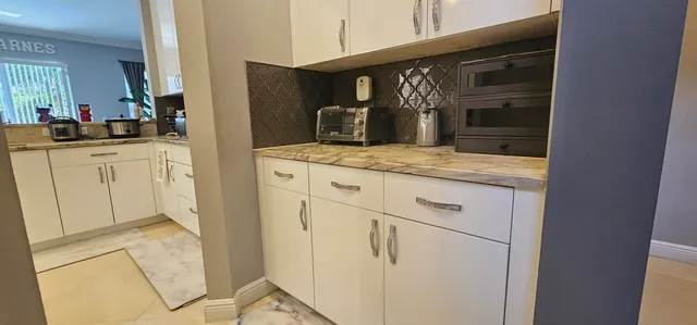 a kitchen with stainless steel appliances a stove refrigerator and microwave