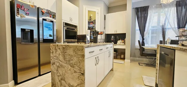 a kitchen with stainless steel appliances a stove microwave and refrigerator