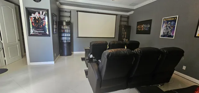 a room with furniture projector and screen