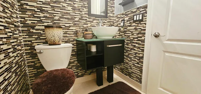 a outdoor space with patio couch and a fireplace