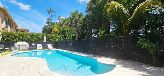 a view of house with swimming pool outdoor seating