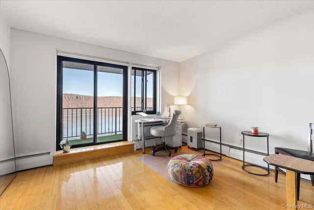 a living room with furniture and a floor to ceiling window