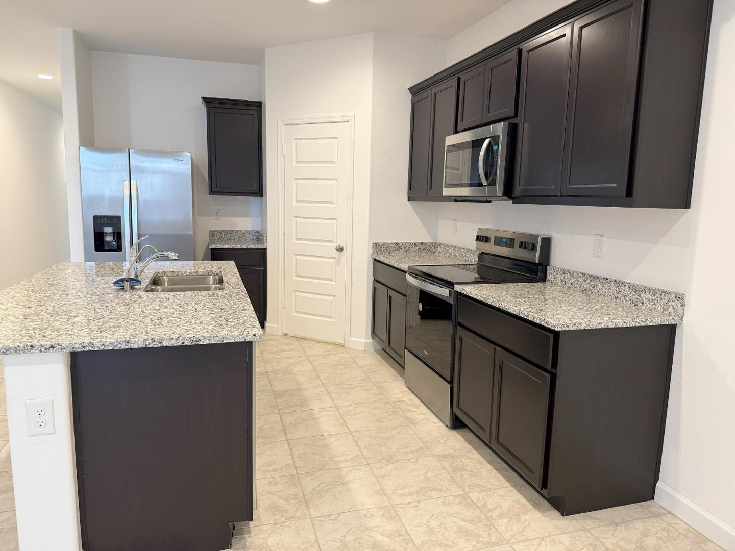 1840 West Spaulding Avenue Apache Junction, AZ 85120 - Photo 27 of 53 a kitchen with stainless steel appliances granite countertop a sink stove and refrigerator