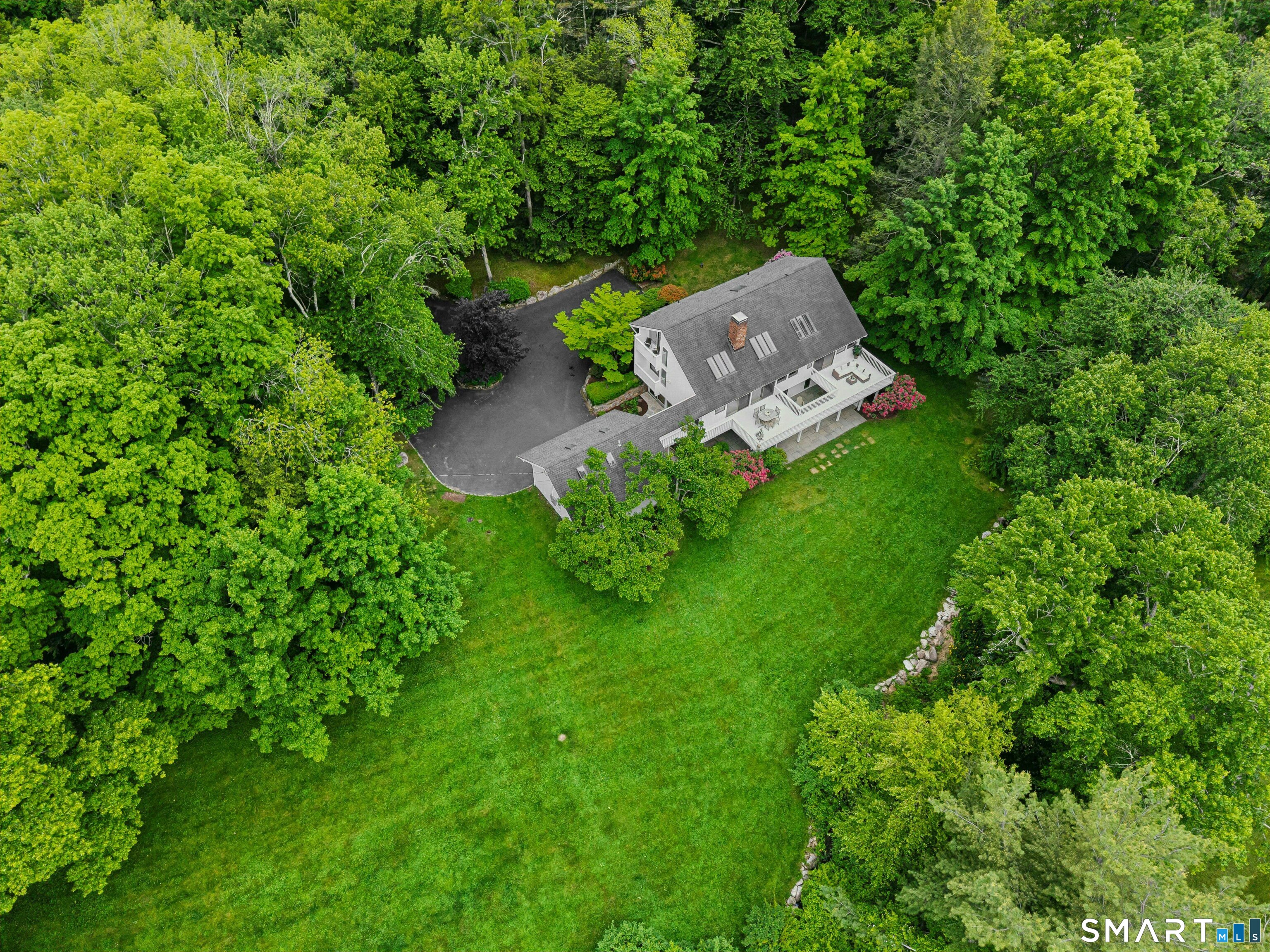 38 Old Redding Road Weston, CT 06883 - Photo 2 of 40 Designed to fully embrace its striking setting, this home offers a wide deck, large patio, five balconies and grand windows framing views.