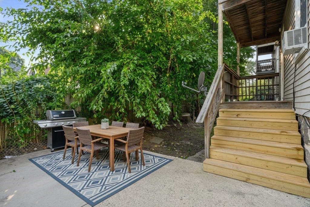 193 Florence Street, Unit 1 Boston, MA 02131 - Photo 11 of 16 a view of a dinning tables and chairs in patio