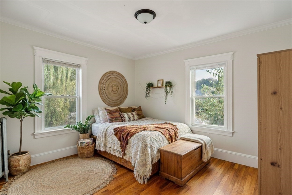 193 Florence Street, Unit 1 Boston, MA 02131 - Photo 3 of 16 a living room with a bed furniture and a window