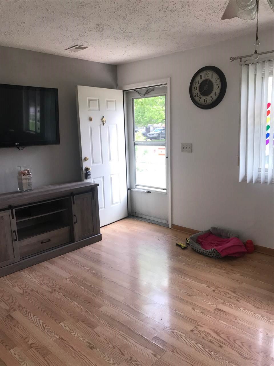 7502 Randy Road Machesney Park, IL 61115 - Photo 3 of 16 a view of an empty room and window with wooden floor