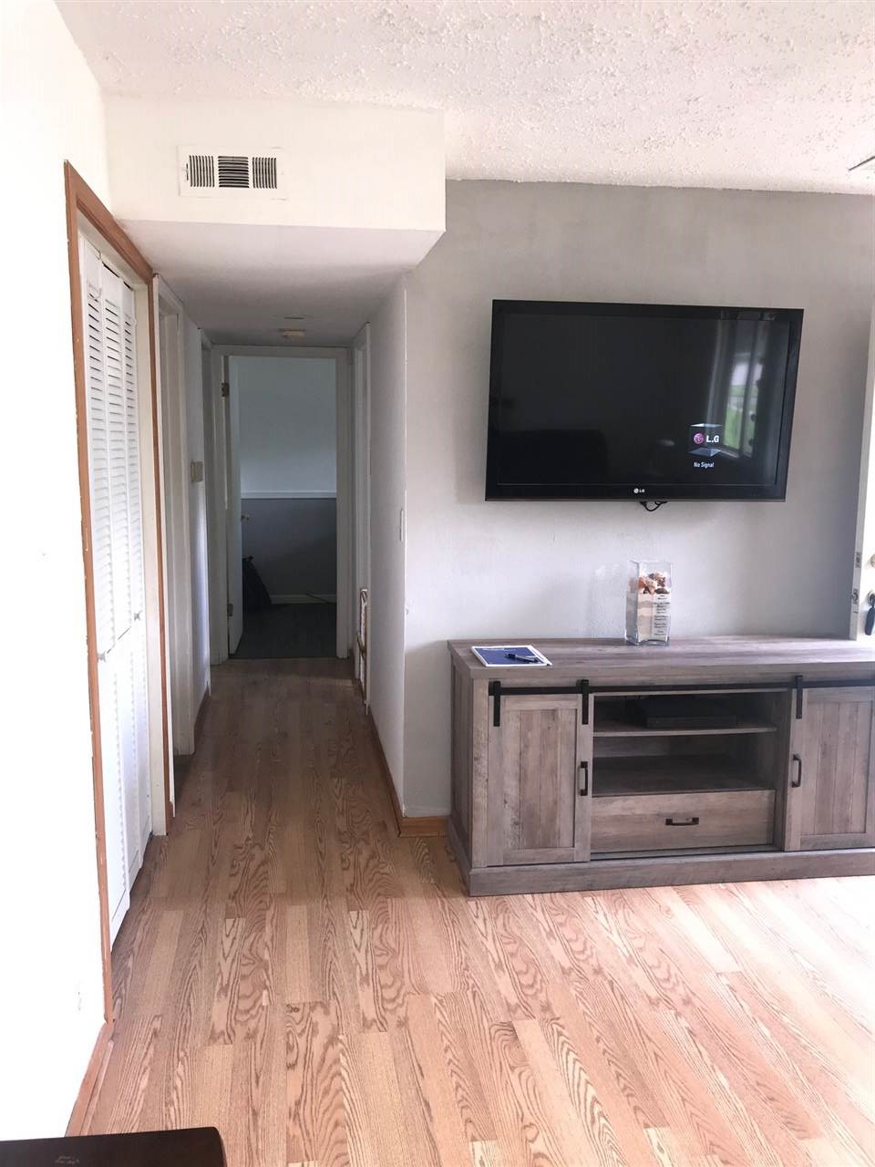 7502 Randy Road Machesney Park, IL 61115 - Photo 4 of 16 a living room with a flat screen tv and view kitchen