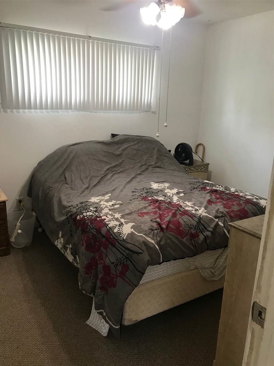 7502 Randy Road Machesney Park, IL 61115 - Photo 9 of 16 a bed sitting in a bedroom next to a window