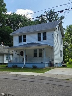 819 Keeney Street Akron, OH 44310 - Photo 2 of 24 Two-story residence featuring white siding, a covered front porch with a light blue foundation, and a dark shingle roof