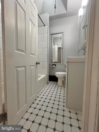 a bathroom with a sink a toilet and a shower