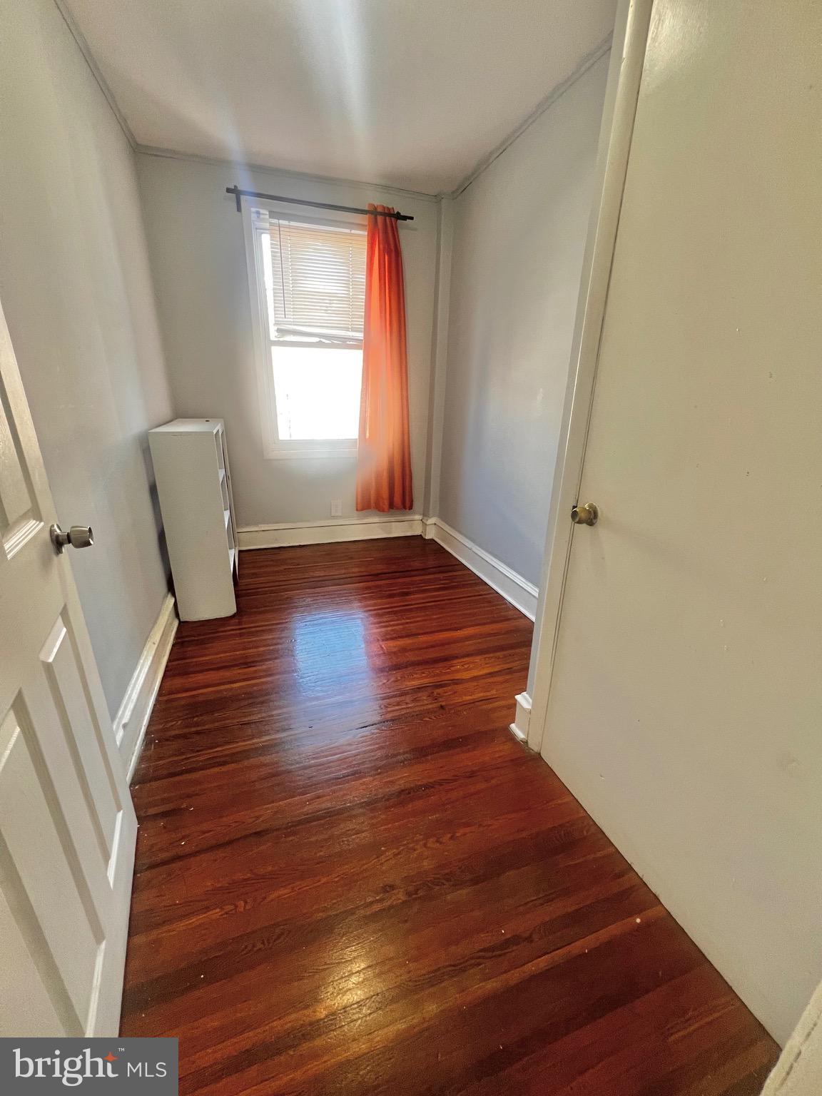 7321 Garman Street Philadelphia, PA 19153 - Photo 12 of 18 a view of an empty room with wooden floor and a window