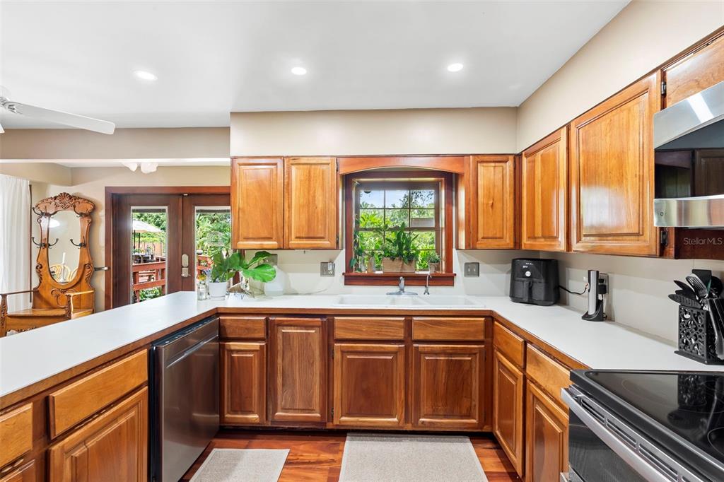 1056 Reynolds Road De Leon Springs, FL 32130 - Photo 13 of 74 a kitchen with a sink a counter top space and stainless steel appliances