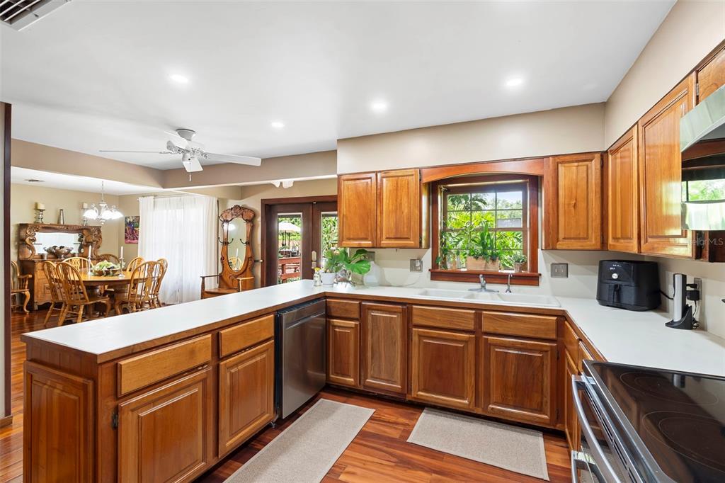 1056 Reynolds Road De Leon Springs, FL 32130 - Photo 16 of 74 a kitchen with a sink stove and cabinets