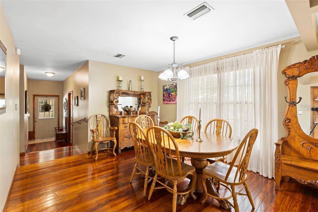 1056 Reynolds Road De Leon Springs, FL 32130 - Photo 18 of 74 a view of a dining room with furniture window and wooden floor