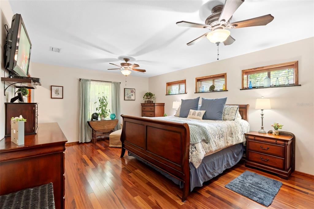 1056 Reynolds Road De Leon Springs, FL 32130 - Photo 19 of 74 a bedroom with bed and a chandelier