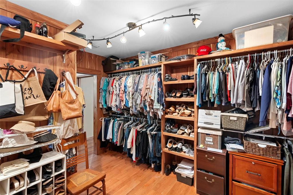 1056 Reynolds Road De Leon Springs, FL 32130 - Photo 21 of 74 a view of walk in closet with clothes and shoes
