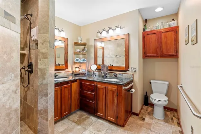 a kitchen with stainless steel appliances a stove a sink dishwasher and a refrigerator with wooden floor