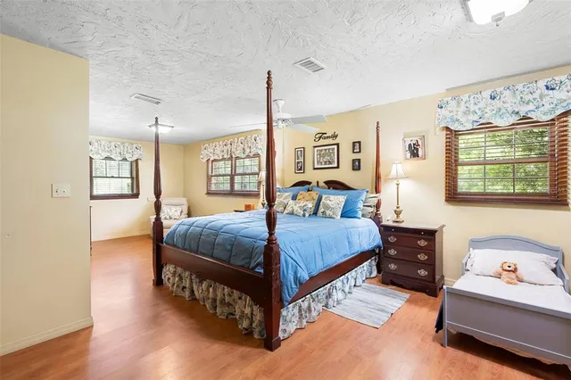 a balcony with wooden floor and outdoor seating