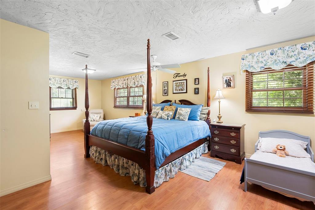 1056 Reynolds Road De Leon Springs, FL 32130 - Photo 24 of 74 a bedroom with a bed and wooden floor