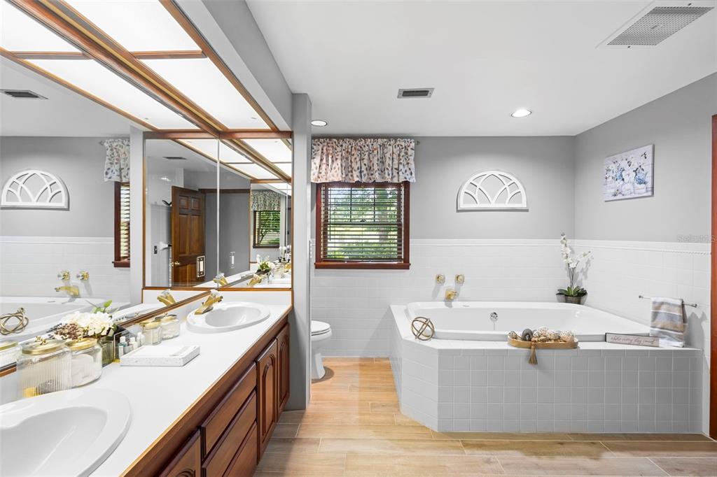 1056 Reynolds Road De Leon Springs, FL 32130 - Photo 25 of 74 a spacious bathroom with a tub a sink and mirror
