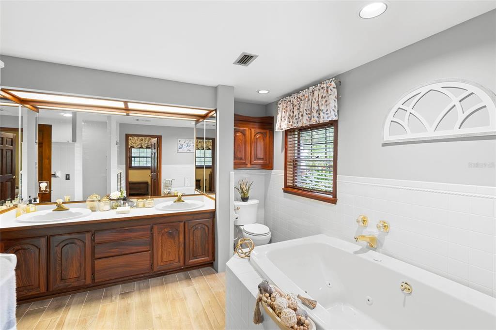 1056 Reynolds Road De Leon Springs, FL 32130 - Photo 26 of 74 a bathroom with a tub sink and mirror