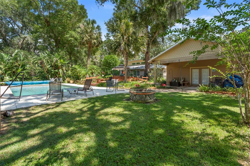 1056 Reynolds Road De Leon Springs, FL 32130 - Photo 37 of 74 a view of a house with backyard porch and sitting area