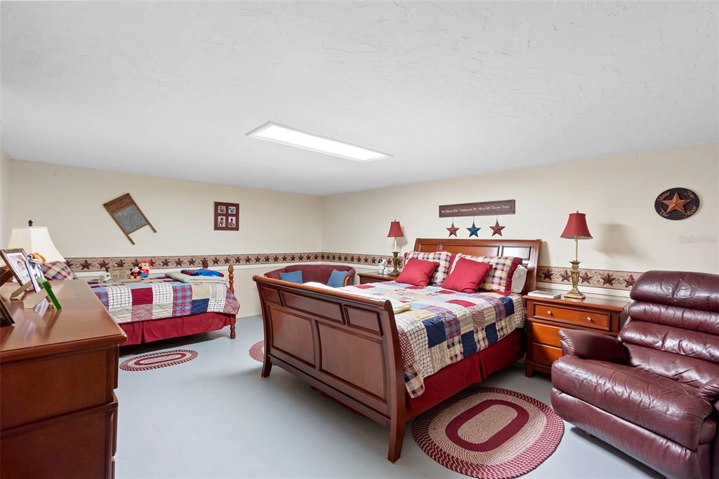 1056 Reynolds Road De Leon Springs, FL 32130 - Photo 40 of 74 a bedroom with a bed couch and a window