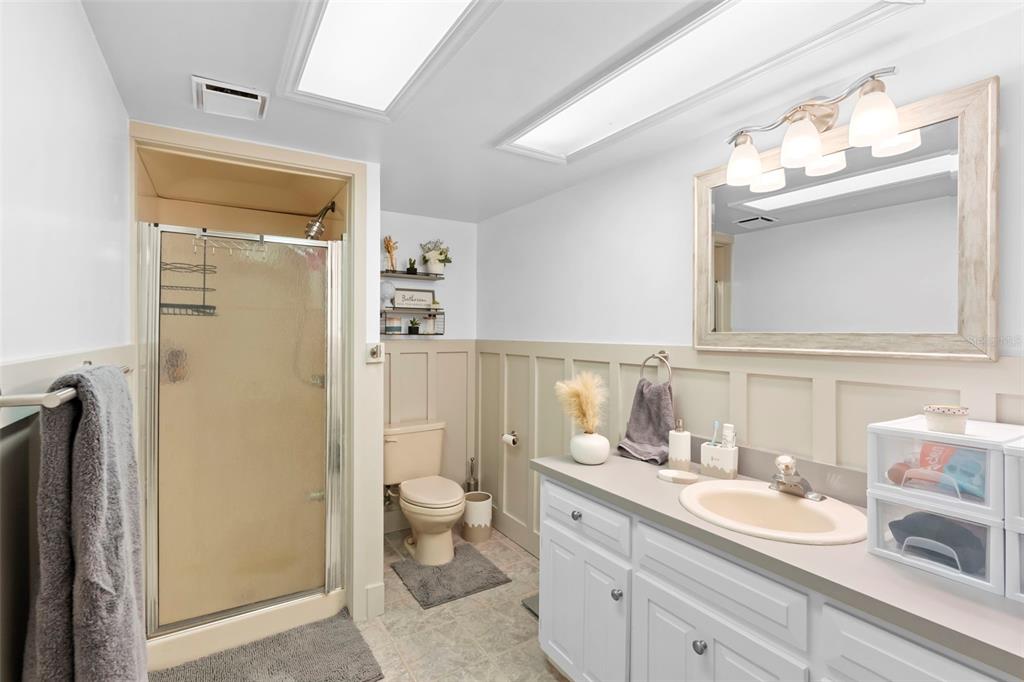 1056 Reynolds Road De Leon Springs, FL 32130 - Photo 41 of 74 a bathroom with a double vanity sink mirror and shower
