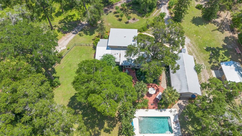 1056 Reynolds Road De Leon Springs, FL 32130 - Photo 5 of 74 an aerial view of a house with a yard and lake view