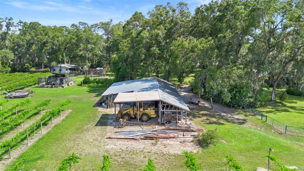 1056 Reynolds Road De Leon Springs, FL 32130 - Photo 52 of 74 a view of a patio with table and chairs under an umbrella