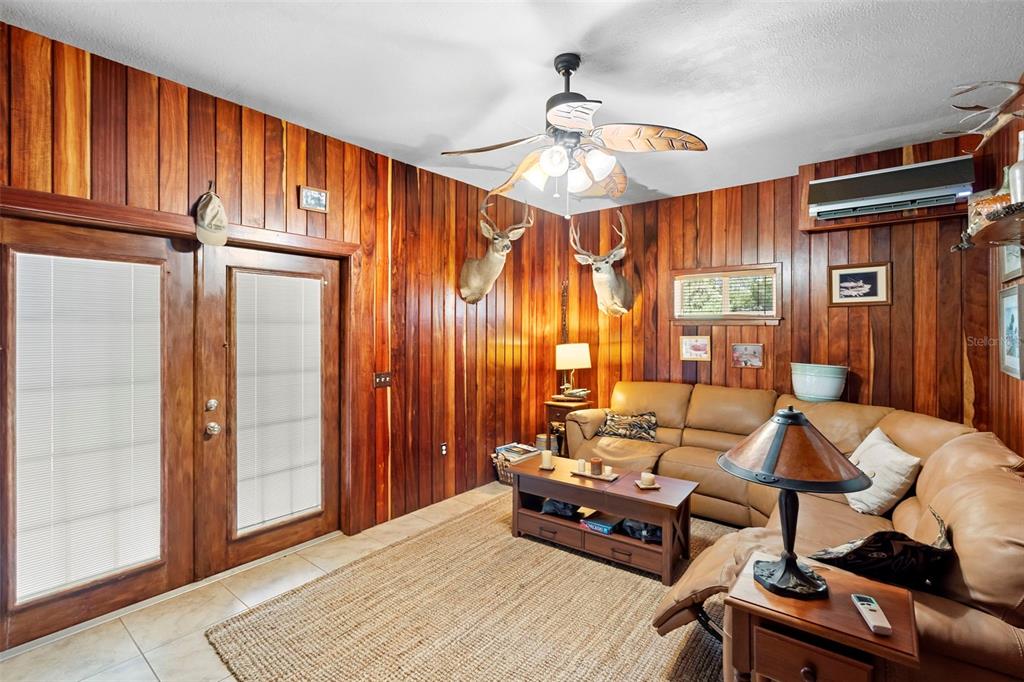 1056 Reynolds Road De Leon Springs, FL 32130 - Photo 56 of 74 a living room with furniture and a chandelier