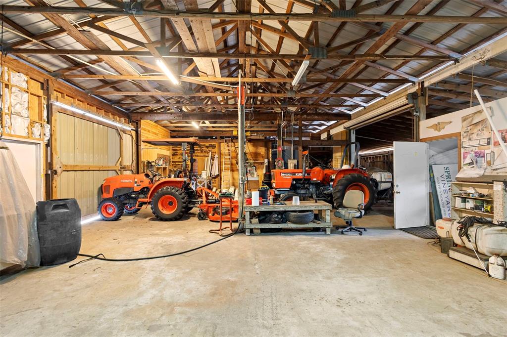 1056 Reynolds Road De Leon Springs, FL 32130 - Photo 67 of 74 a view of a garage with a bike and car