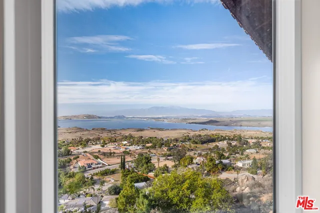 a living room with furniture a flat screen tv and kitchen view