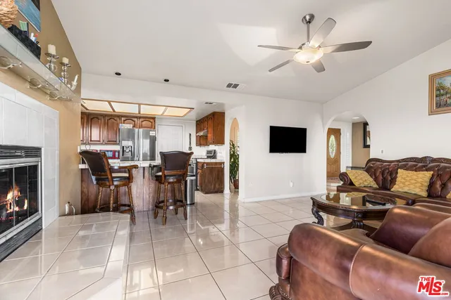 a living room with furniture and a floor to ceiling window