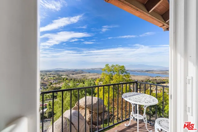 a view of staircase with lots of frames on wall and wooden floor