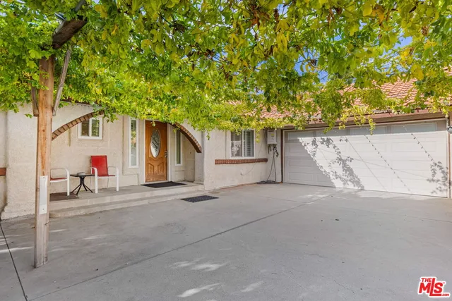 a view of a hallway with dining area and chandelier