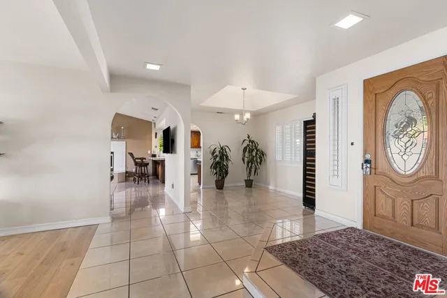 a dining room with furniture and view of kitchen
