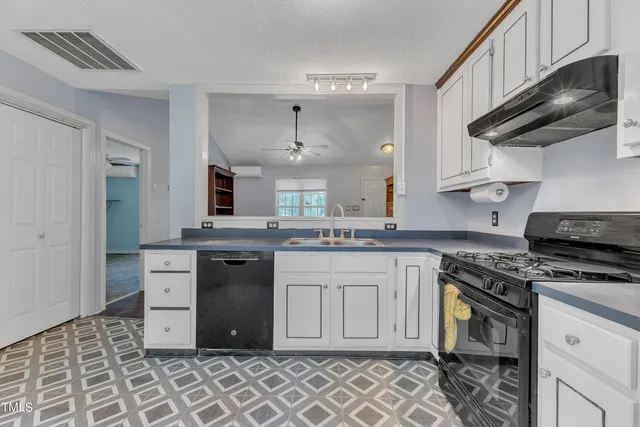 a stove top oven sitting inside of a kitchen