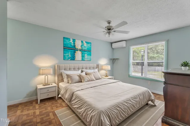 a bedroom with a large bed and a window