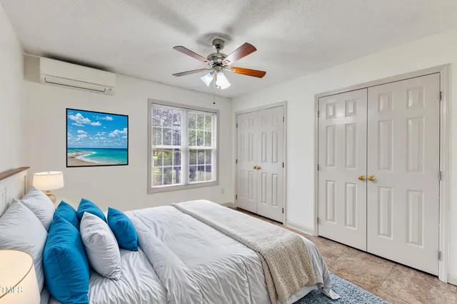 a front view of house with yard and trees in the background