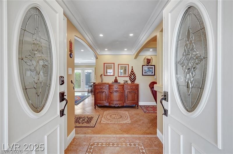 2410 Doherty Way Henderson, NV 89014 - Photo 11 of 63 Entrance foyer with baseboards, recessed lighting, light tile patterned floors, ornamental molding, and inlaid floor details