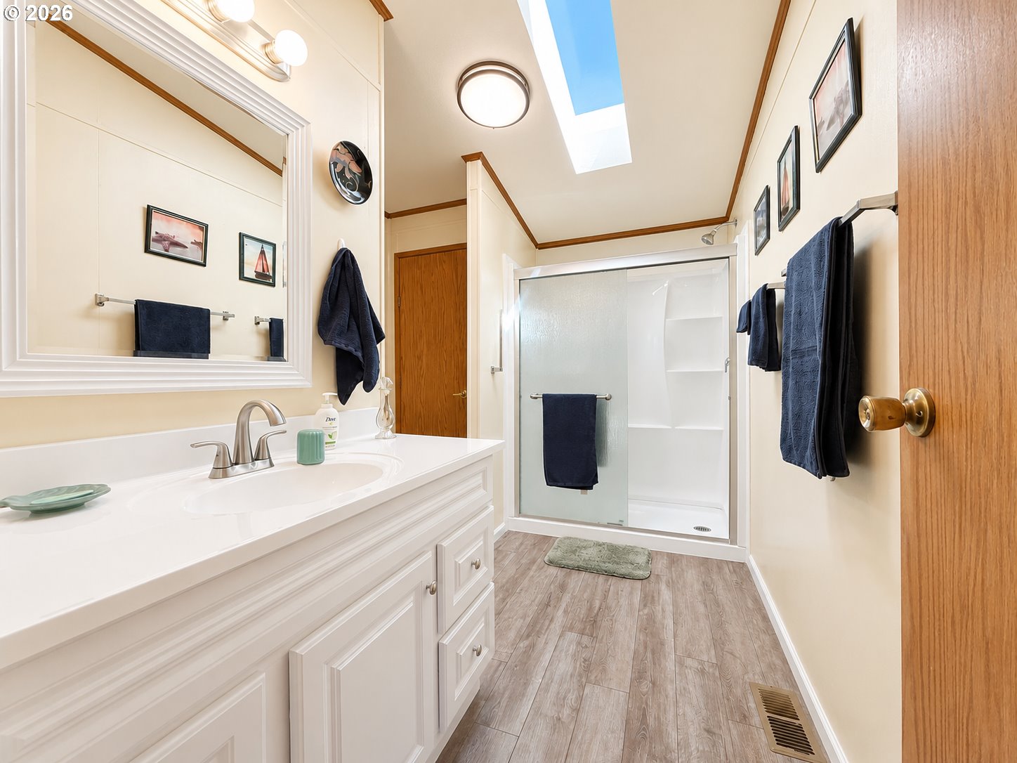 16219 Lower Harbor Road, Unit 16 Brookings, OR 97415 - Photo 17 of 40 a spacious bathroom with a sink a toilet a mirror and shower