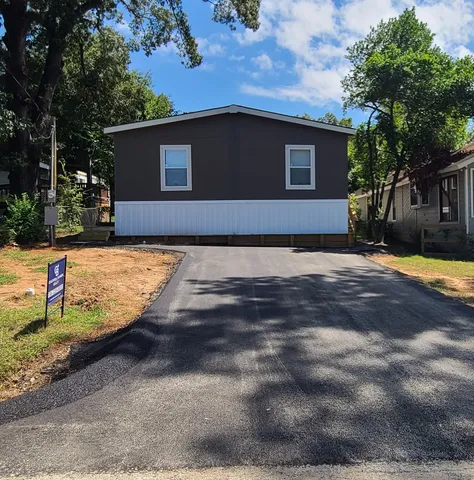 an empty room with window wooden floor and a ceiling fan