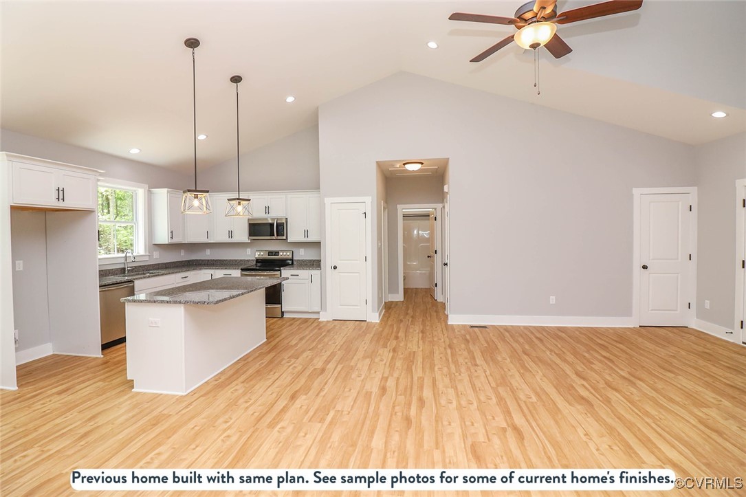 1676 Patterson Road Buckingham, VA 23921 - Photo 16 of 24 a kitchen with granite countertop a stove a sink and a refrigerator